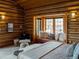Log cabin bedroom featuring a window seat with a scenic view and comfortable seating at 29095 Summit Ranch Dr, Golden, CO 80401