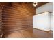 Spacious bedroom with hardwood floors and a log cabin wall with white drywall at 29095 Summit Ranch Dr, Golden, CO 80401