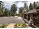 Large driveway with log cabin home, fountain, and decorative statue at 29095 Summit Ranch Dr, Golden, CO 80401