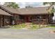 Charming log cabin with a red door, front porch, beautiful landscaping, and scenic surroundings at 29095 Summit Ranch Dr, Golden, CO 80401