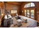 Inviting living room with large windows, stone fireplace, and comfortable seating area at 29095 Summit Ranch Dr, Golden, CO 80401