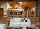 Open living room featuring log cabin walls and wood beamed ceilings at 29095 Summit Ranch Dr, Golden, CO 80401