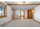 Bright living room featuring white walls, wood trim, and doorway to bathroom at 29095 Summit Ranch Dr, Golden, CO 80401