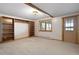 Carpeted living room with wooden trim, built-in shelves, and view to the outside at 29095 Summit Ranch Dr, Golden, CO 80401