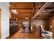 Open-concept living space with wood floors, log beams, and access to the kitchen and dining areas at 29095 Summit Ranch Dr, Golden, CO 80401
