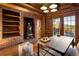Cozy home office with custom wood features, shelves, and wood-burning fireplace at 29095 Summit Ranch Dr, Golden, CO 80401