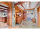 Inviting entryway with slate tile flooring, wood walls, and a charming antique cabinet at 608 Patty Dr, Evergreen, CO 80439