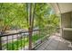 Balcony view with lush trees, and a black metal railing overlooking the neighborhood at 1635 N Franklin St, Denver, CO 80218