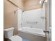 Bright bathroom featuring a white tub with shower, grab bar, and updated fixtures at 1635 N Franklin St, Denver, CO 80218