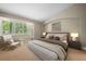 Cozy bedroom with a large window, side chair, and comfortable bed at 1635 N Franklin St, Denver, CO 80218