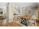 Open-concept dining area with wood floors, staircase with metal railing, and neutral color scheme at 1635 N Franklin St, Denver, CO 80218