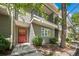 Inviting townhouse exterior with red front door, balcony, and landscaped front yard at 1635 N Franklin St, Denver, CO 80218