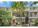 Charming townhouse with balconies, red doors, and lush landscaping offering an inviting curb appeal at 1635 N Franklin St, Denver, CO 80218