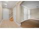 Well-lit hallway featuring tile flooring, multiple doors, and access to stairs at 1635 N Franklin St, Denver, CO 80218