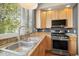 Bright kitchen with stainless steel appliances, light wood cabinets and granite countertops at 1635 N Franklin St, Denver, CO 80218