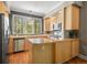 Stylish kitchen with wood cabinets, stainless steel appliances, and center island at 1635 N Franklin St, Denver, CO 80218