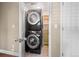 Convenient laundry area with stacked washer and dryer and shelving for storage at 1635 N Franklin St, Denver, CO 80218
