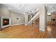 Spacious living room with fireplace, wood floors, and staircase with metal railing at 1635 N Franklin St, Denver, CO 80218