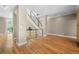 Open-concept living area with wood floors, staircase with metal railing, and neutral color scheme at 1635 N Franklin St, Denver, CO 80218