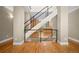 Modern staircase with sleek metal railing and wood stairs, connecting living spaces at 1635 N Franklin St, Denver, CO 80218