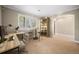Inviting office space with a large window, desk, shelving, and neutral carpet at 1635 N Franklin St, Denver, CO 80218