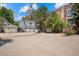 Large parking lot offering plenty of space for vehicles, surrounded by buildings and greenery under a blue sky at 1635 N Franklin St, Denver, CO 80218