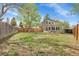 Spacious backyard featuring a lush lawn and mature trees, perfect for outdoor activities and relaxation at 16928 Dandelion Way, Parker, CO 80134
