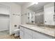 Bathroom with a granite countertop, modern fixtures, and a walk-in closet at 16928 Dandelion Way, Parker, CO 80134