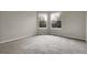 Spacious bedroom with neutral walls, plush carpet, and natural light from the windows at 16928 Dandelion Way, Parker, CO 80134