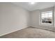 This is a bedroom with neutral walls, carpet, and a sun-filled window at 16928 Dandelion Way, Parker, CO 80134