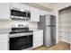 Kitchen features stainless steel appliances and white cabinets for a modern feel at 16928 Dandelion Way, Parker, CO 80134