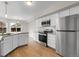 Modern kitchen with stainless steel appliances, granite countertops, and ample cabinet space at 16928 Dandelion Way, Parker, CO 80134