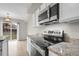 Modern kitchen featuring stainless steel appliances and granite countertops at 16928 Dandelion Way, Parker, CO 80134