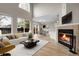 Bright living room with large windows, a fireplace, and an adjacent dining area at 16928 Dandelion Way, Parker, CO 80134