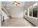 Bright living room featuring hardwood floors, large windows, and a modern ceiling fan at 16928 Dandelion Way, Parker, CO 80134