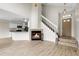 Inviting living room featuring a fireplace, open staircase, and access to the kitchen at 16928 Dandelion Way, Parker, CO 80134