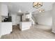 Open floor plan with hardwood floors connecting the kitchen and the living room with staircase at 16928 Dandelion Way, Parker, CO 80134