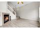 Open concept living space with a fireplace, staircase, and seamless flow to other areas at 16928 Dandelion Way, Parker, CO 80134