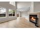 Spacious living room with a fireplace, lots of natural light, and access to the backyard at 16928 Dandelion Way, Parker, CO 80134