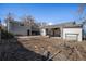 Backyard features a detached garage, covered patio, and yard with potential for landscaping and outdoor living at 1940 E 95Th Ave, Thornton, CO 80229