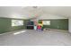 Spacious bonus room with vaulted ceilings, green accent wall, and windows for ample natural light at 1940 E 95Th Ave, Thornton, CO 80229