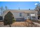 Exterior view of home with a covered front porch and stone foundation at 1940 E 95Th Ave, Thornton, CO 80229