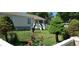 Charming front yard with lush green lawn, rose bushes, and well-placed trees, leading to a cozy home at 1940 E 95Th Ave, Thornton, CO 80229