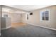 Open living space with a combination of plush carpet and sleek hardwood flooring, creating a cozy yet modern feel at 1940 E 95Th Ave, Thornton, CO 80229