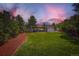 Inviting backyard with vibrant green lawn, mature trees, and manicured landscaping at 4475 S Routt St, Littleton, CO 80127