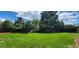Expansive backyard featuring lush lawn, privacy fence, and mature trees at 4475 S Routt St, Littleton, CO 80127