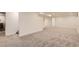 Spacious basement area with carpet and light walls, creates a functional and inviting living space at 4475 S Routt St, Littleton, CO 80127