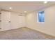 Finished basement with modern lighting and window well at 4475 S Routt St, Littleton, CO 80127