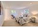Cozy bedroom with neutral tones, recessed lighting, and two windows at 4475 S Routt St, Littleton, CO 80127