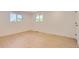 Bright bedroom featuring wood floors, two windows, and white walls providing a clean, modern aesthetic at 4475 S Routt St, Littleton, CO 80127